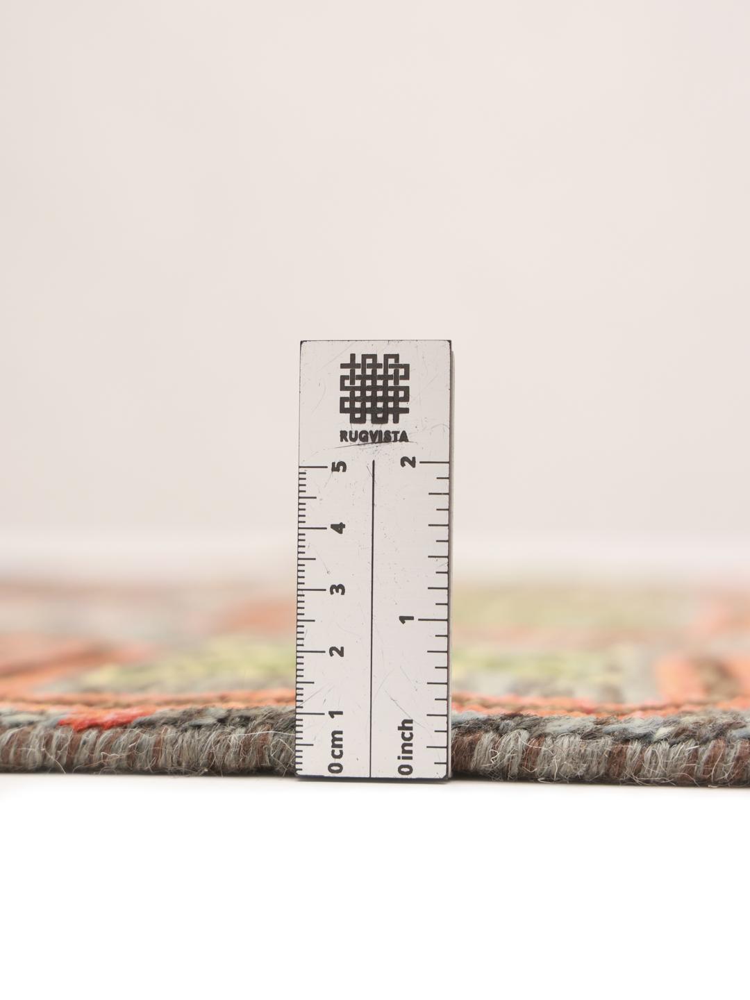 Hand-knotted Middle Eastern runner with a colourful pattern on a grey background
