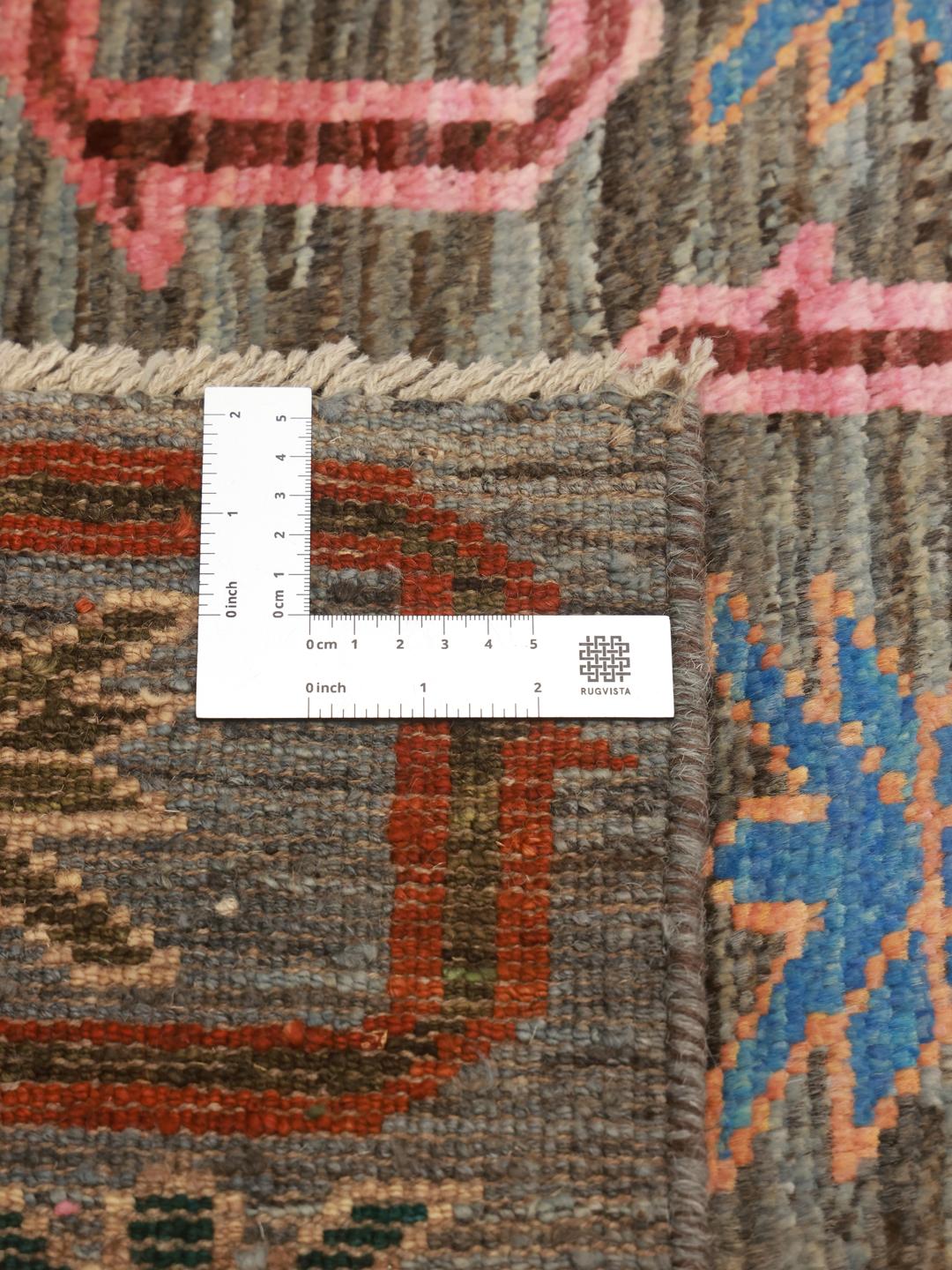 Hand-knotted Middle Eastern runner with a colourful pattern on a grey background
