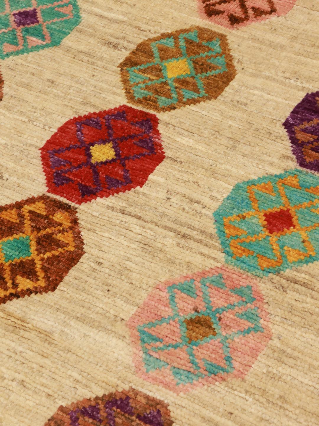 Hand-knotted Afghan Berber Colourful rug with vibrant geometric motifs on a beige background.