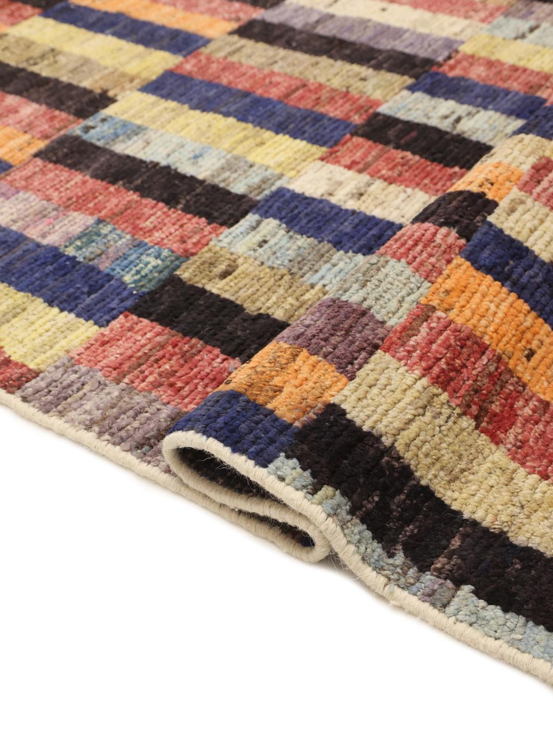 A vibrant, multi-coloured hand-knotted rug from Afghanistan with a block pattern.