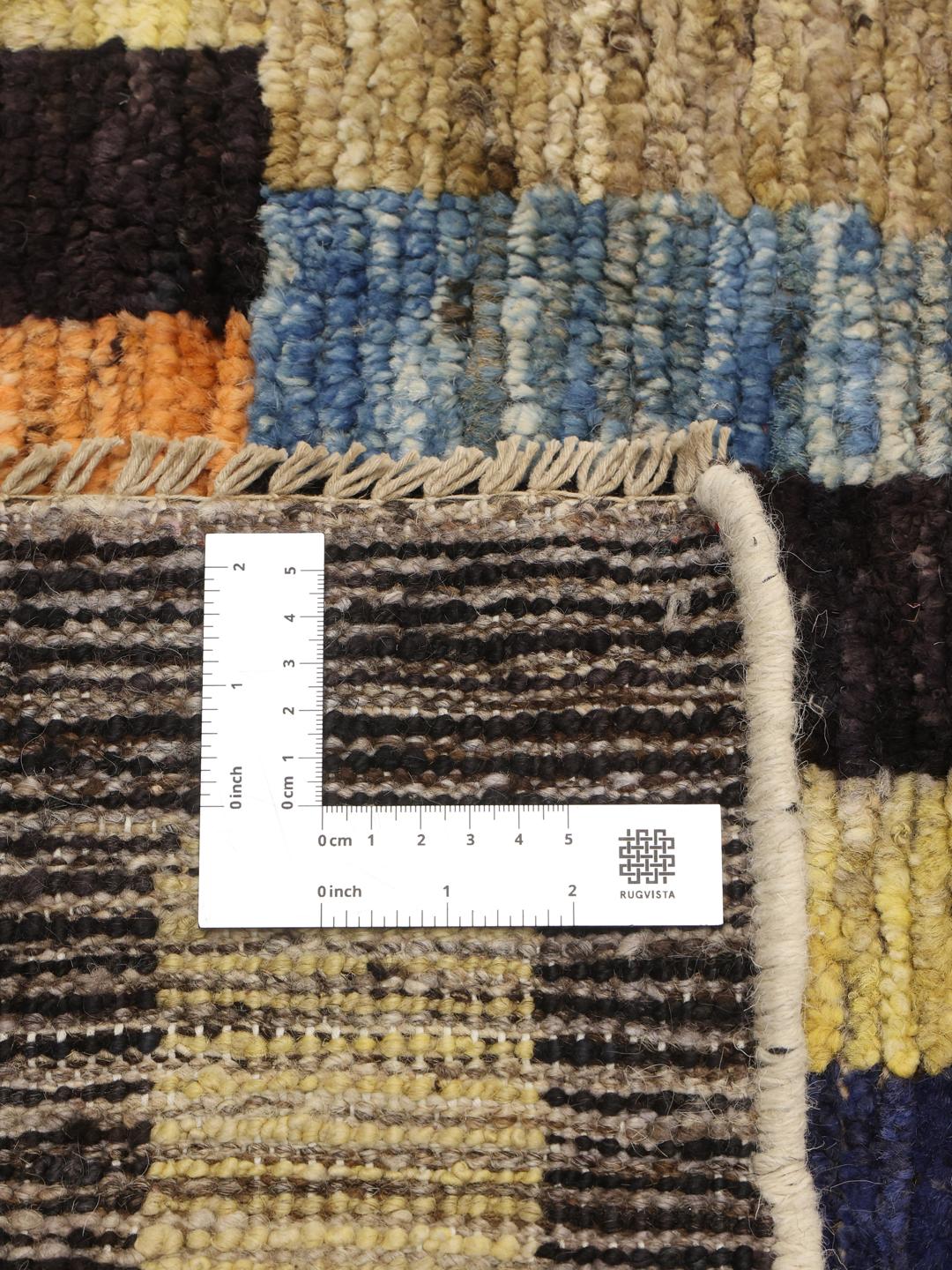 A vibrant, multi-coloured hand-knotted rug from Afghanistan with a block pattern.