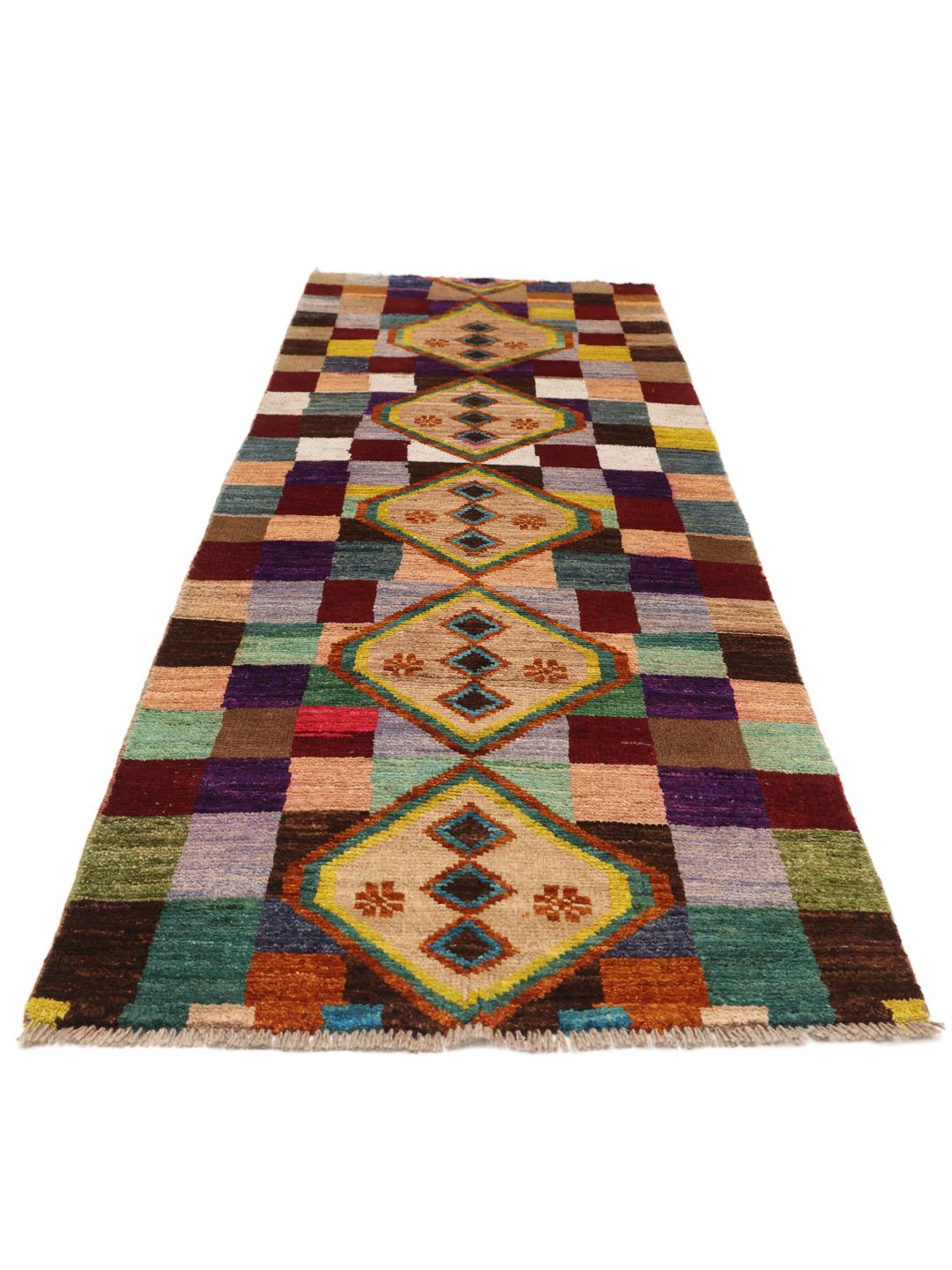 Hand-knotted Afghan runner with vibrant geometric diamond motifs and multicolor squares.
