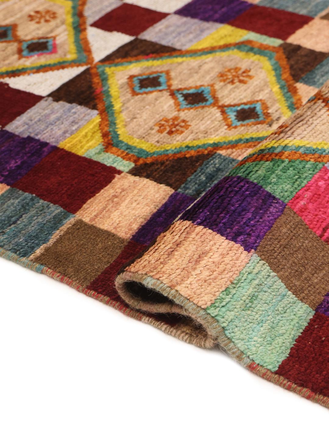 Hand-knotted Afghan runner with vibrant geometric diamond motifs and multicolor squares.