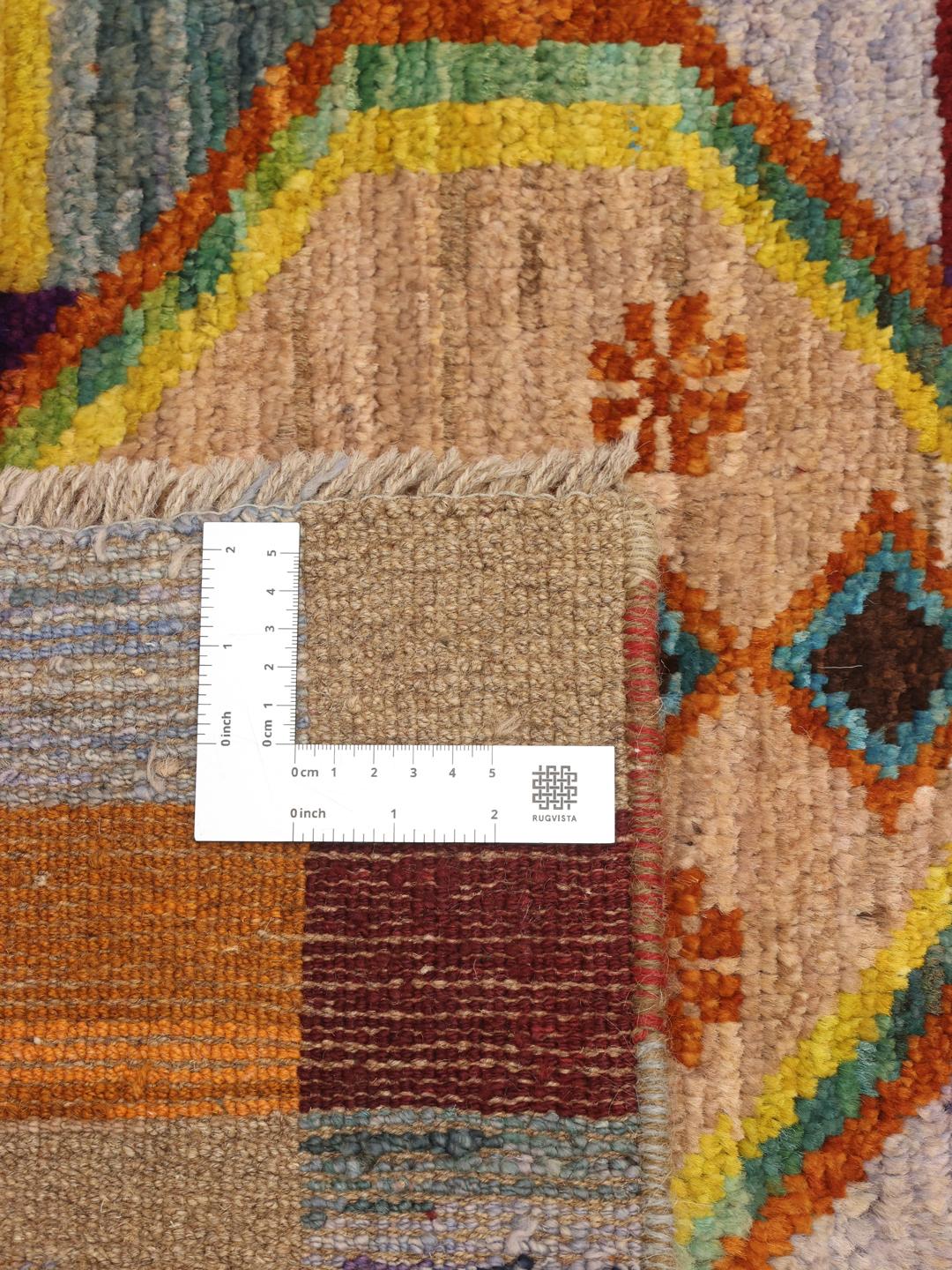 Hand-knotted Afghan runner with vibrant geometric diamond motifs and multicolor squares.