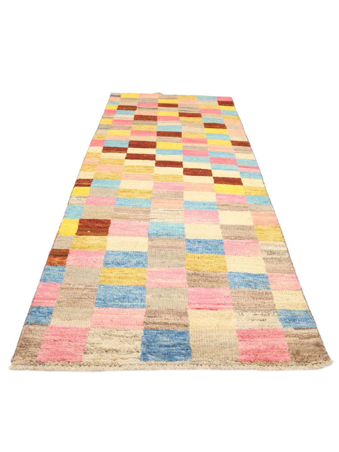 A colourful hand-knotted Afghan runner rug with a vibrant checkerboard pattern