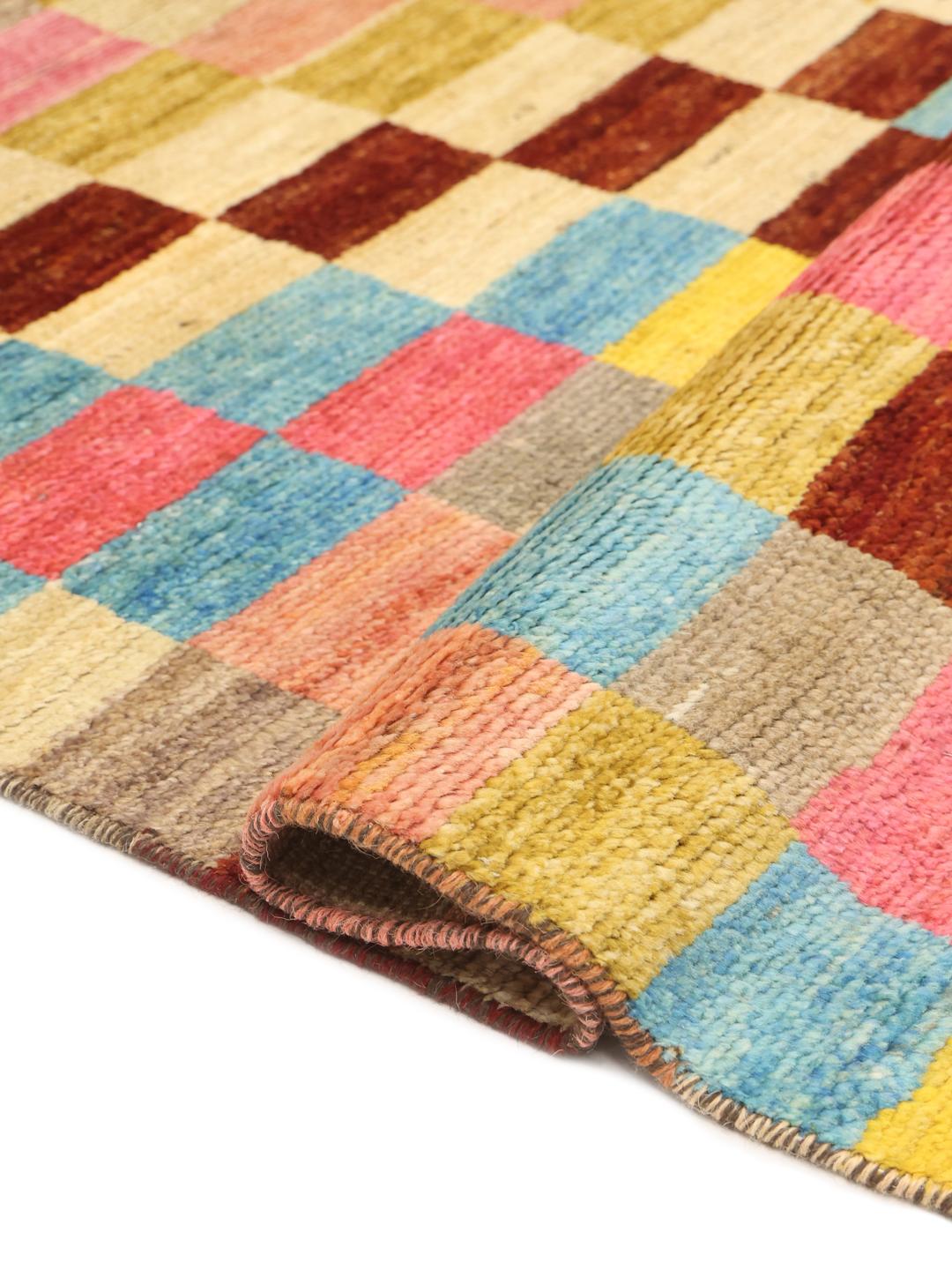 A colourful hand-knotted Afghan runner rug with a vibrant checkerboard pattern