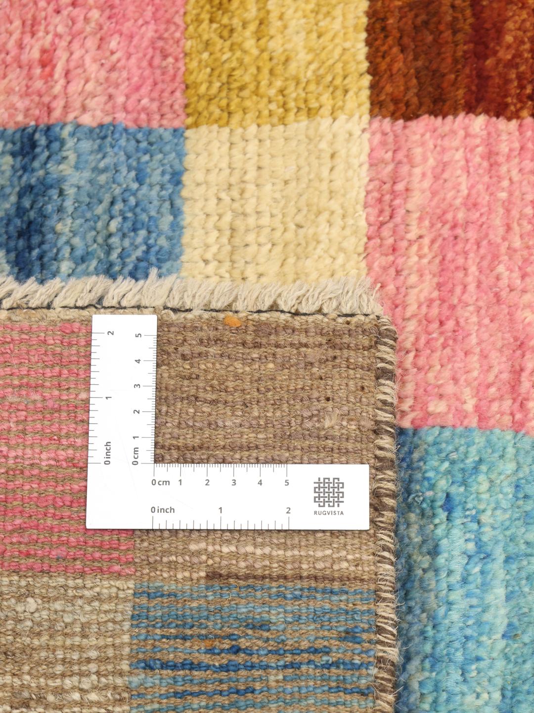A colourful hand-knotted Afghan runner rug with a vibrant checkerboard pattern