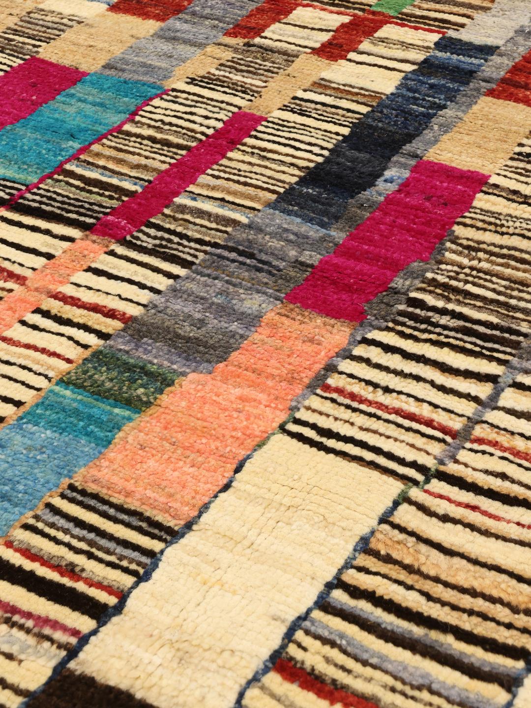 Hand-knotted colourful Afghan rug with a vibrant, rhythmic design.