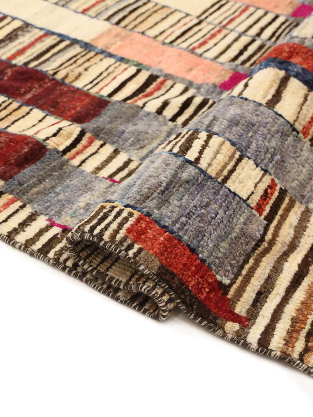 Hand-knotted colourful Afghan rug with a vibrant, rhythmic design.