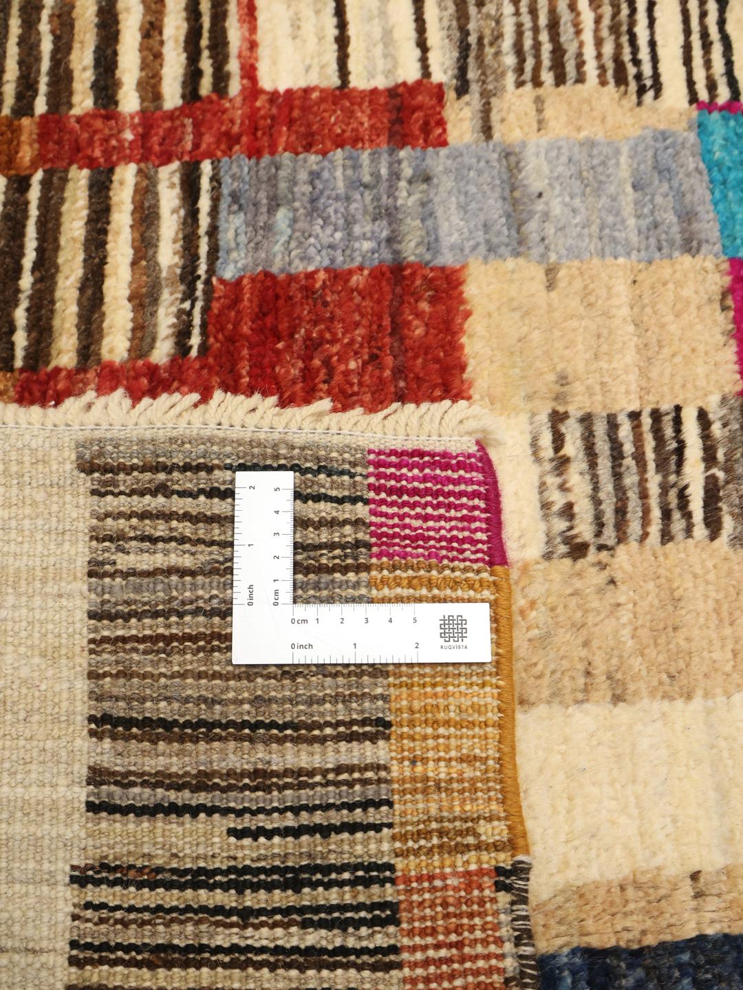 Hand-knotted colourful Afghan rug with a vibrant, rhythmic design.