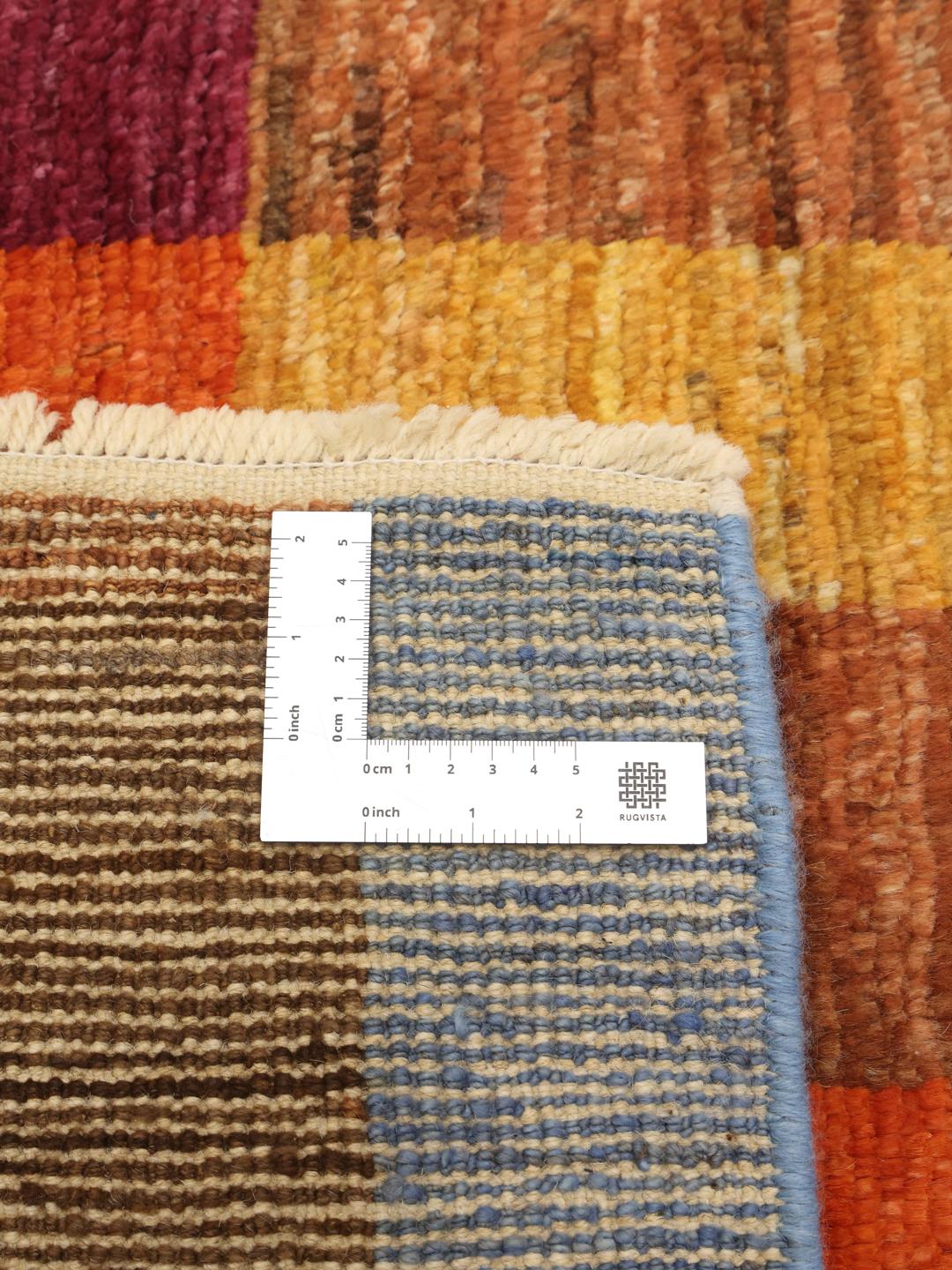 A vibrant, hand-knotted multicolor Berber-inspired rug from Afghanistan featuring a geometric grid design.