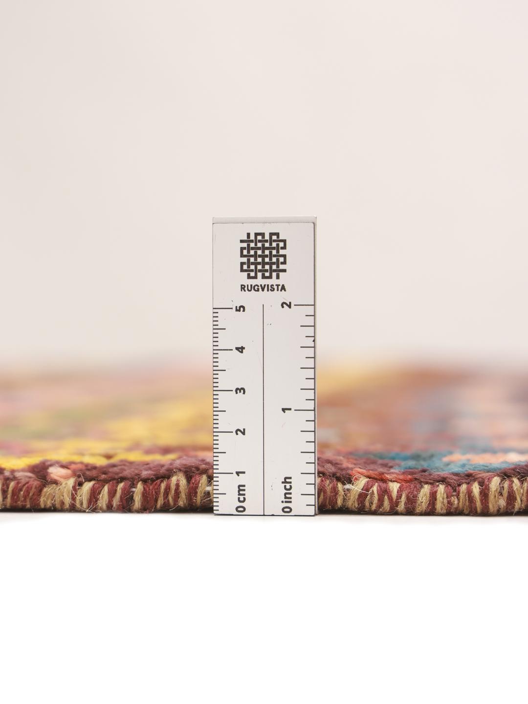 A vibrant, hand-knotted Berber rug from Afghanistan with a geometric multicolored design.