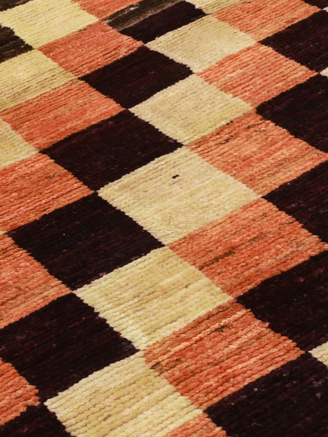 Hand-knotted Berber rug from Afghanistan with a red, black, and beige checkerboard pattern