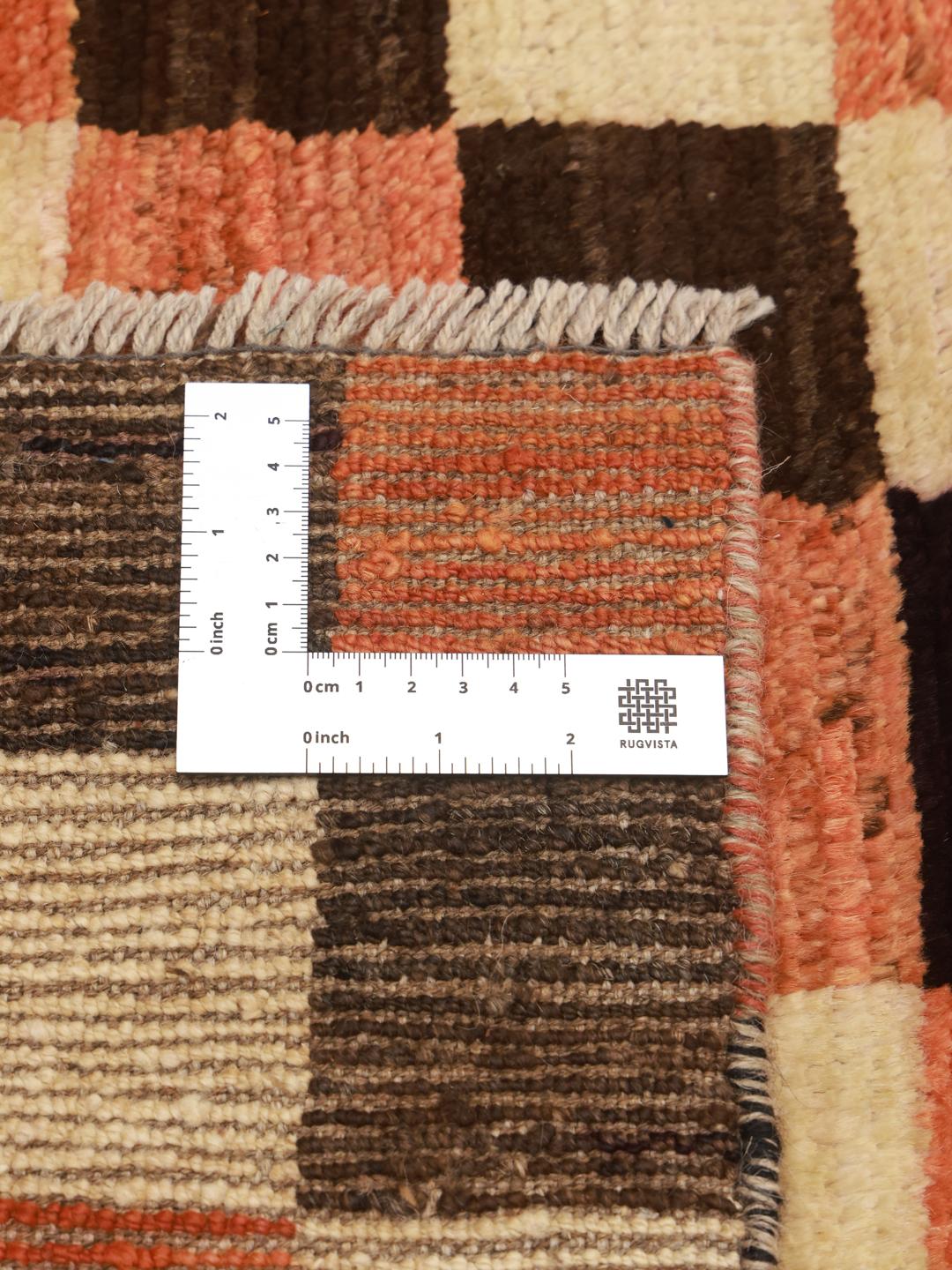 Hand-knotted Berber rug from Afghanistan with a red, black, and beige checkerboard pattern