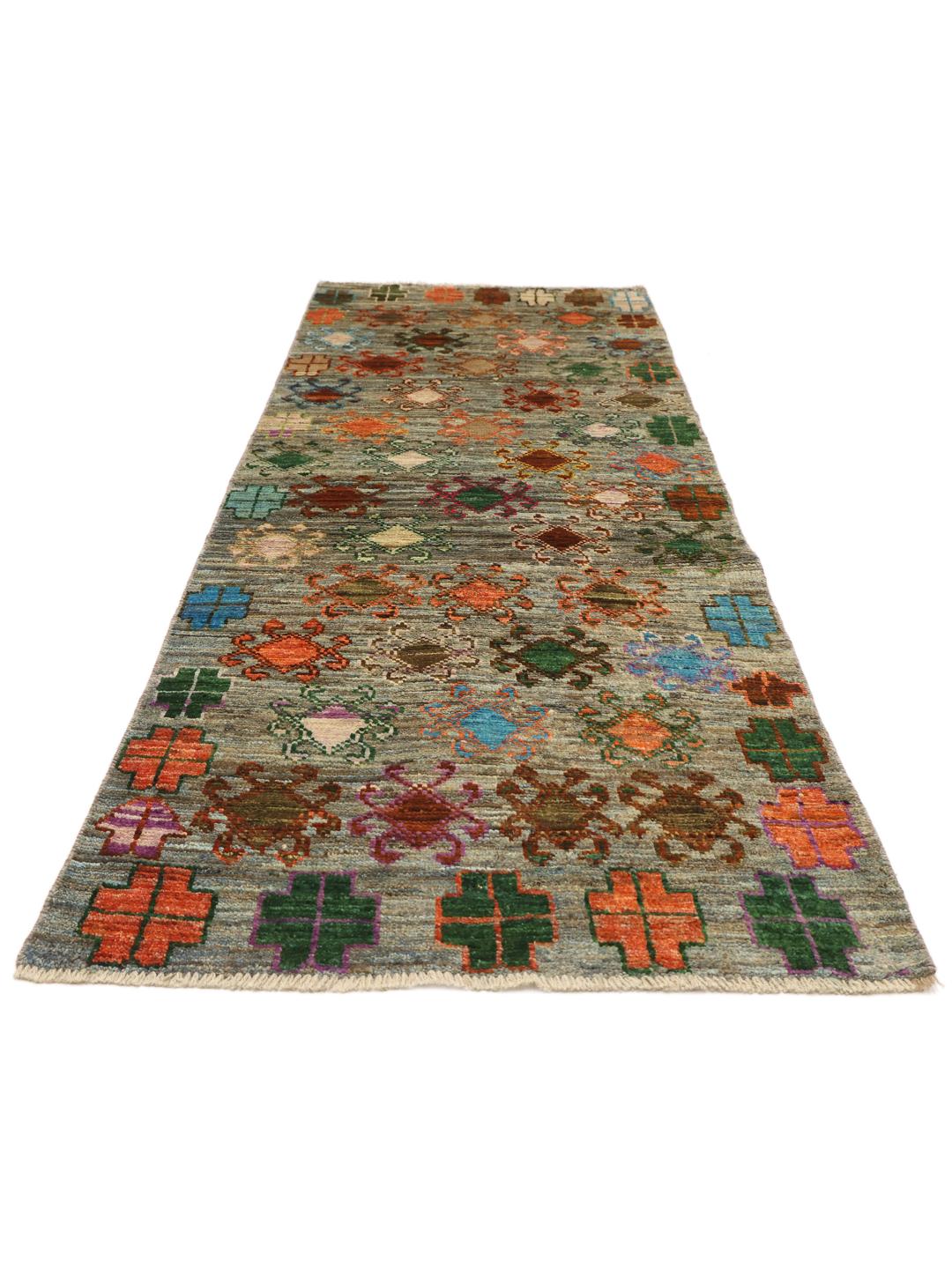 Hand-knotted Afghan runner with colourful motifs on a grey background