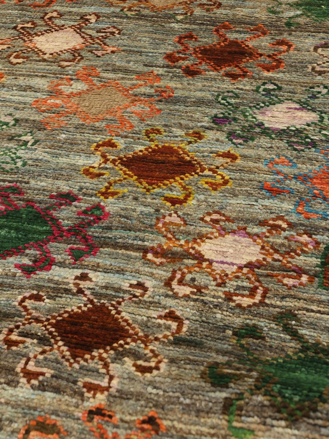 Hand-knotted Afghan runner with colourful motifs on a grey background