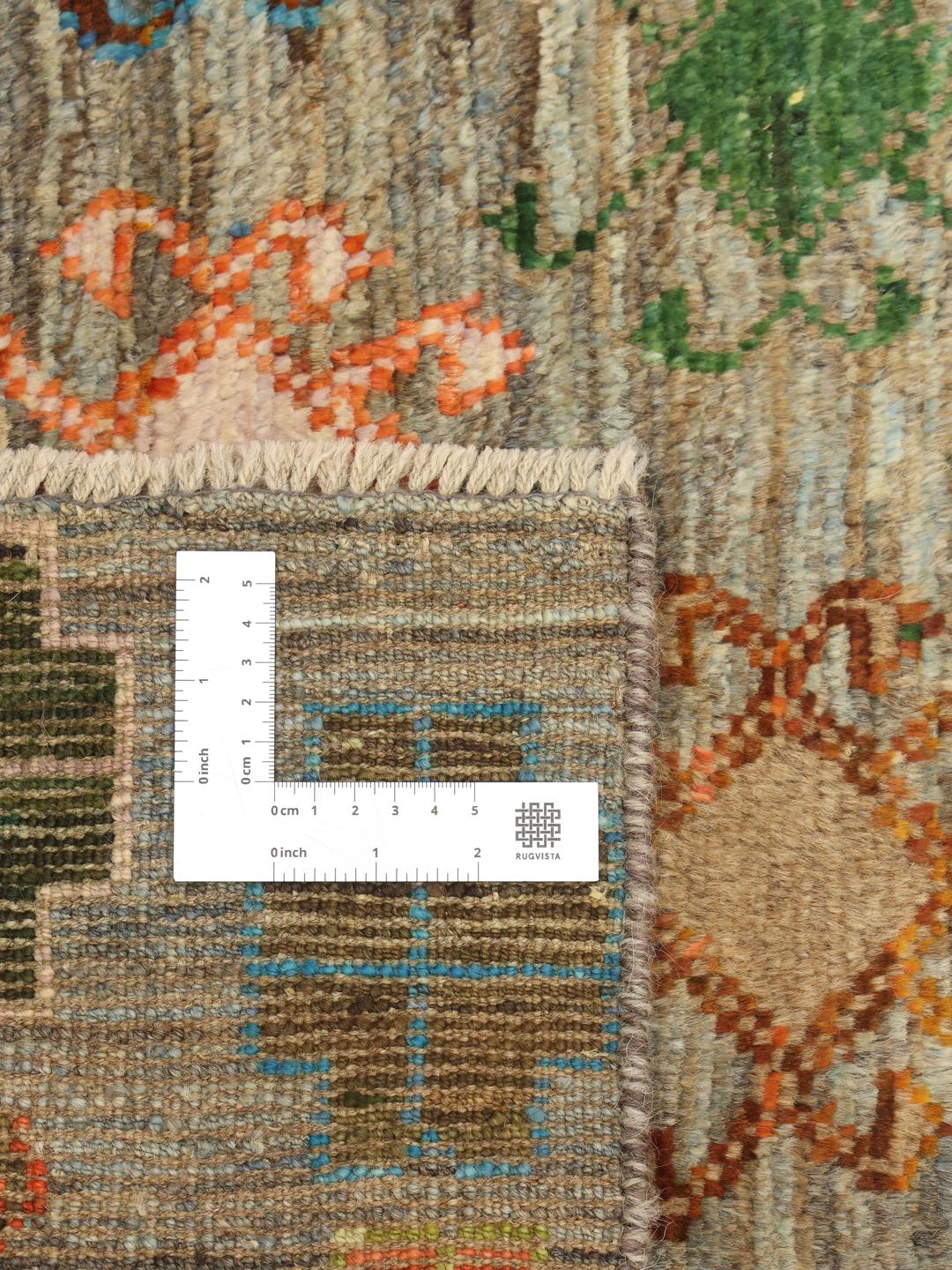 Hand-knotted Afghan runner with colourful motifs on a grey background