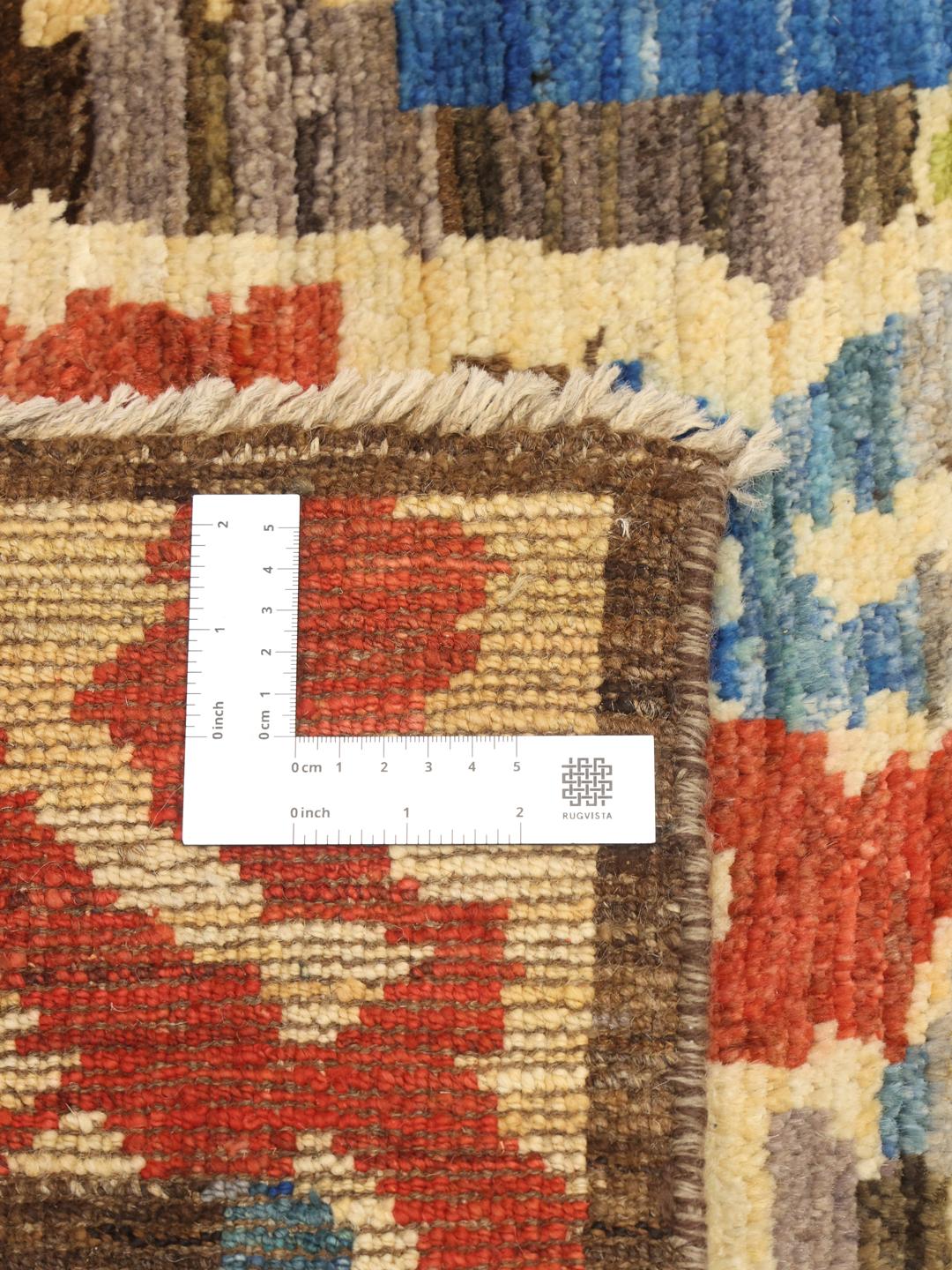 Hand-knotted Afghan rug with vibrant abstract patterns in multicolor