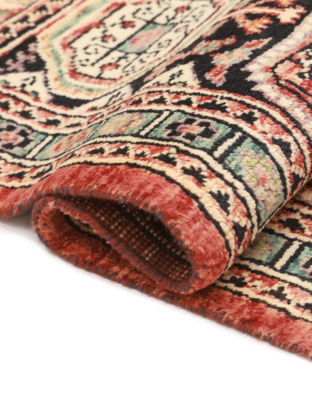 Hand-knotted Kazak rug from Afghanistan in deep red and black tones