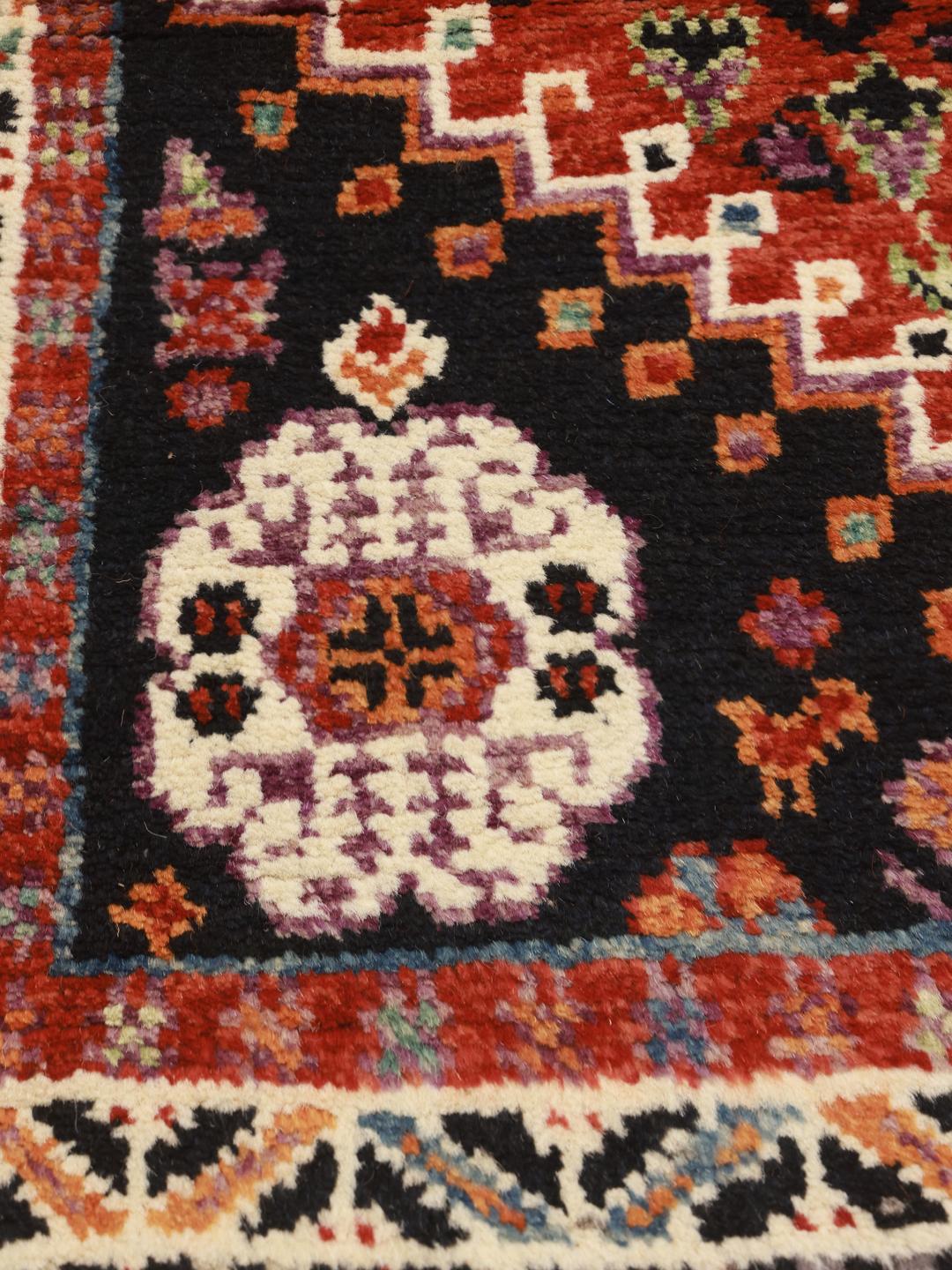 Hand-knotted Kazak rug from Afghanistan in red and black