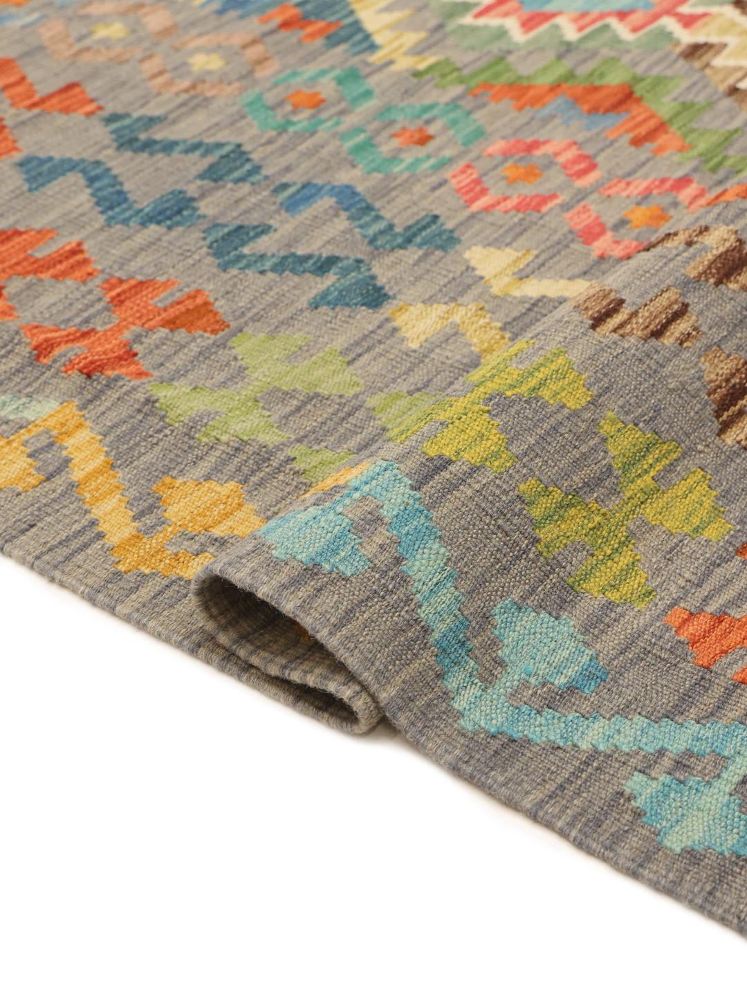 Hand-woven Kelim rug from Afghanistan with a multicolor geometric pattern on a grey background