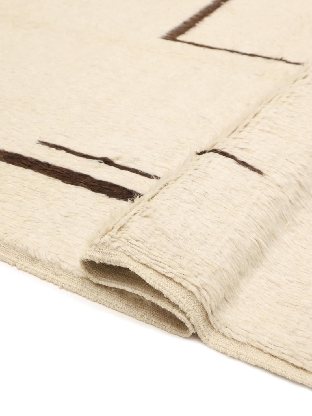 Hand-knotted Afghan rug with minimalist brown lines on a beige background