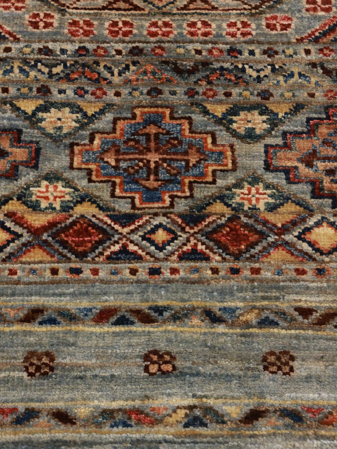 Hand-knotted runner from Afghanistan with blue and red geometric patterns.