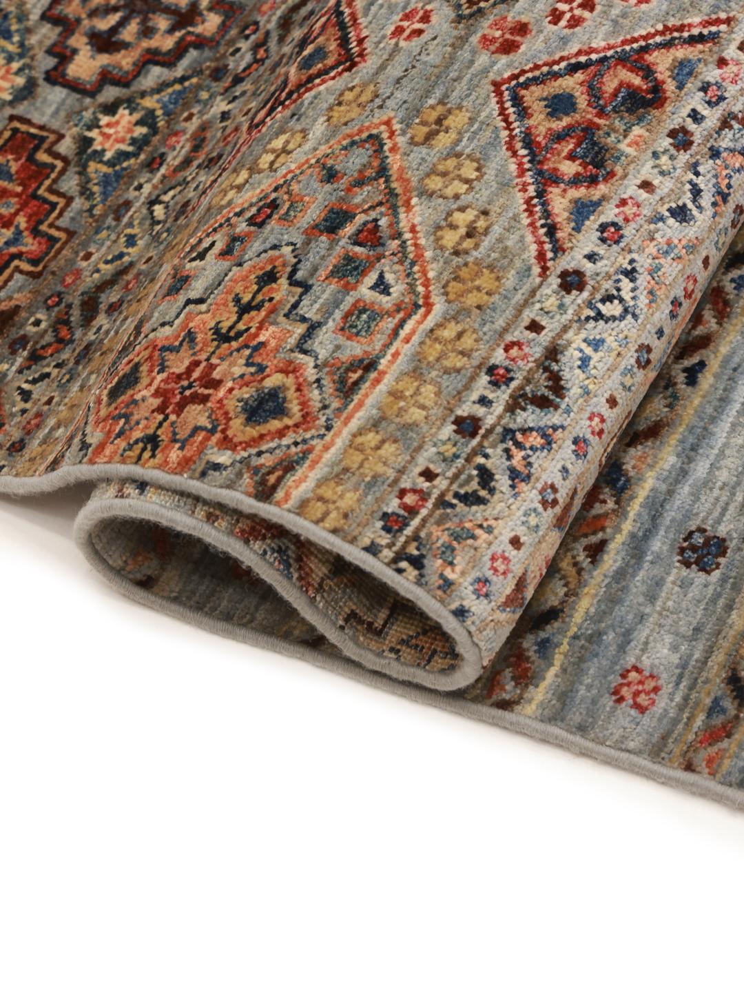 Hand-knotted runner from Afghanistan with blue and red geometric patterns.