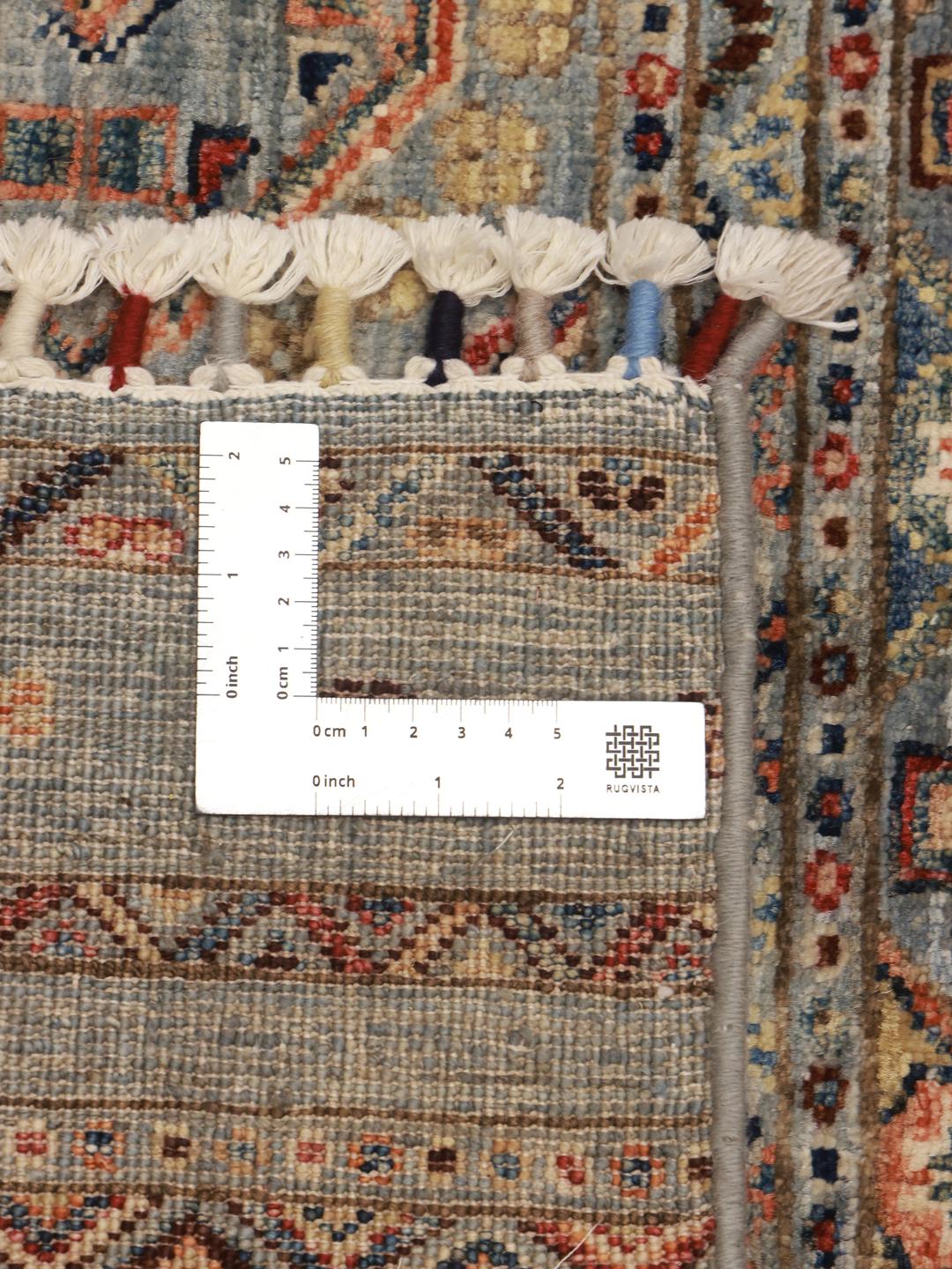 Hand-knotted runner from Afghanistan with blue and red geometric patterns.