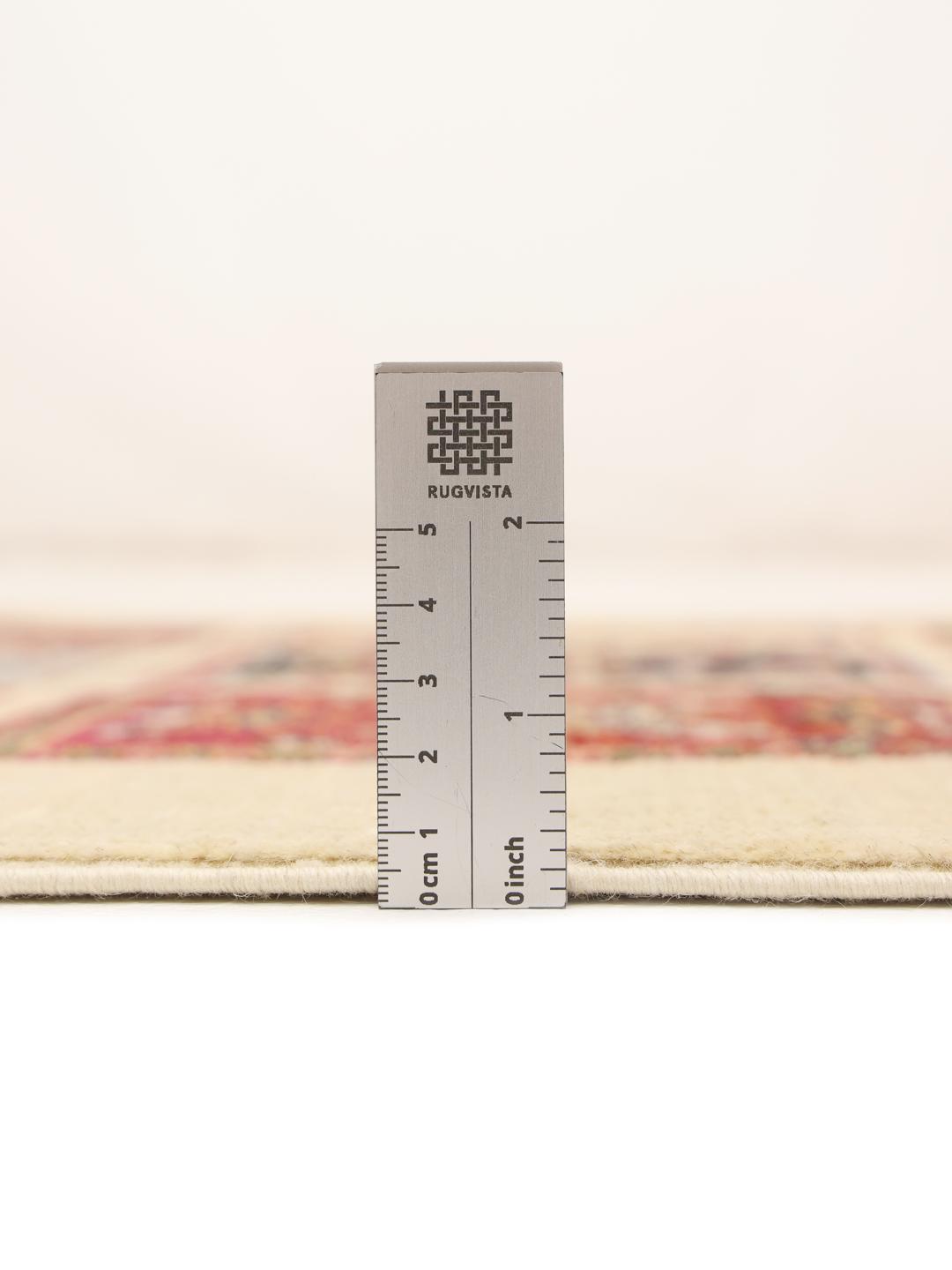 Hand-knotted Afghan runner with colourful floral grid panels on a beige background.