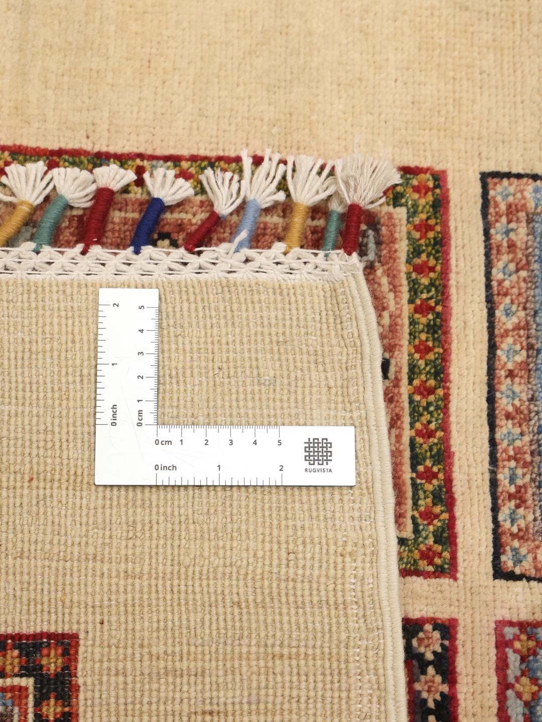 Hand-knotted Afghan runner with colourful floral grid panels on a beige background.