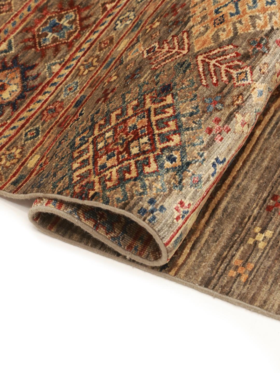 Hand-knotted brown runner rug from Afghanistan with geometric tribal patterns.