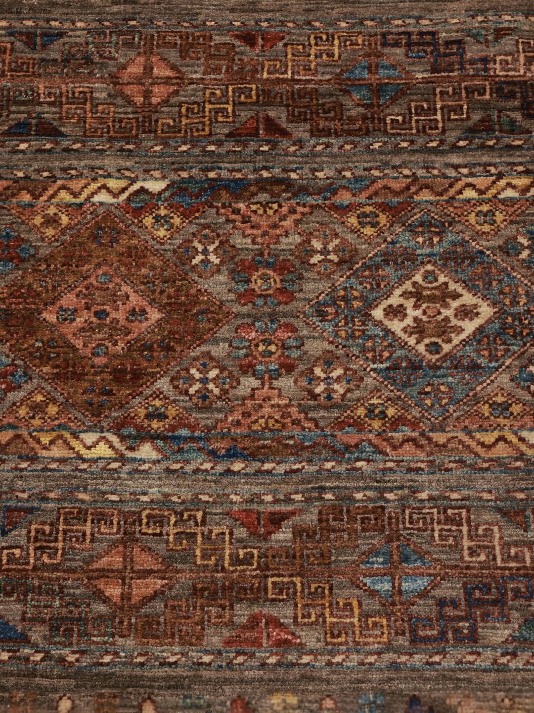 Hand-knotted Afghan runner in brown with geometric border patterns