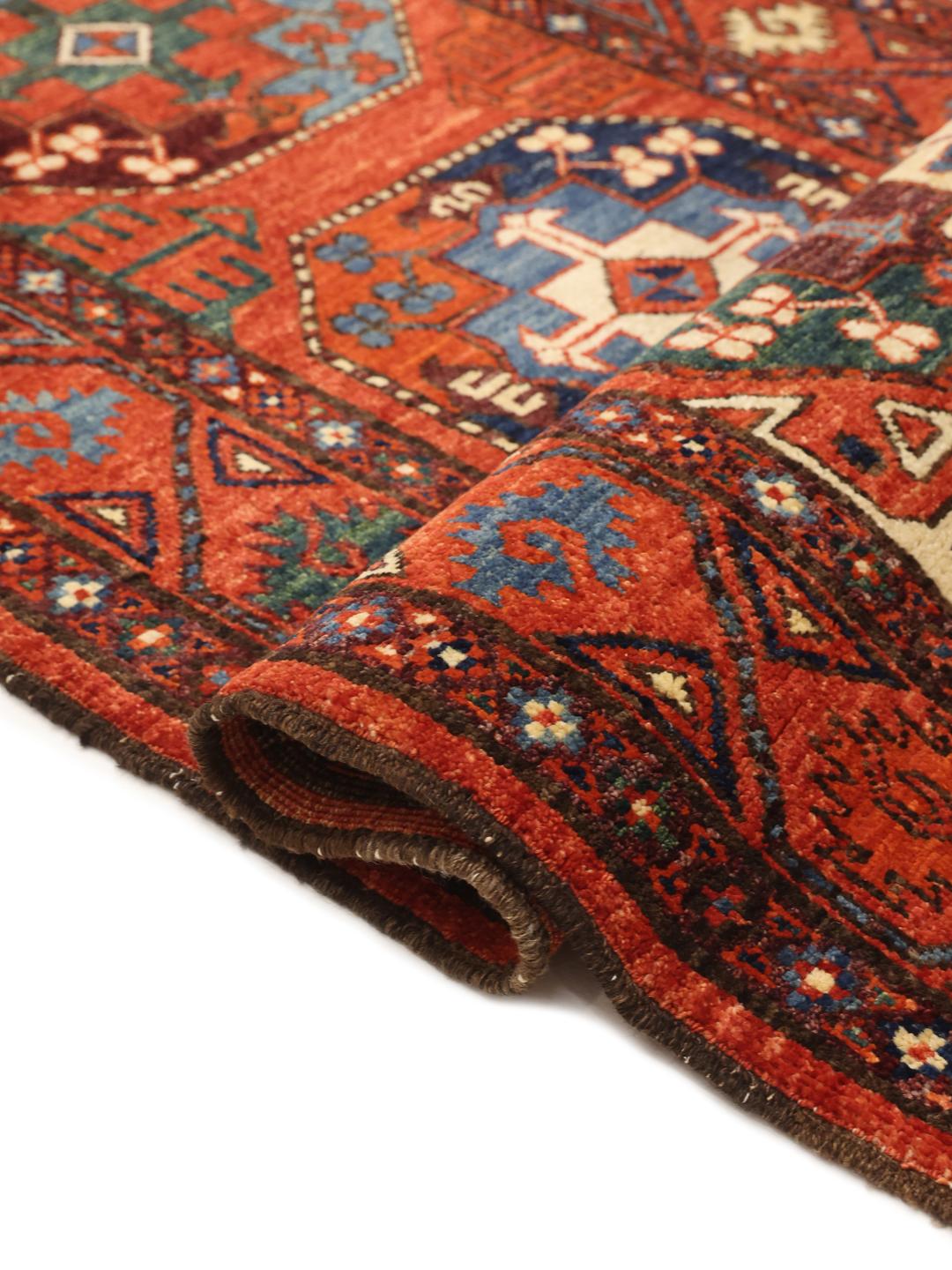 Hand-knotted Panjshir wool runner from the Middle East in red tones.