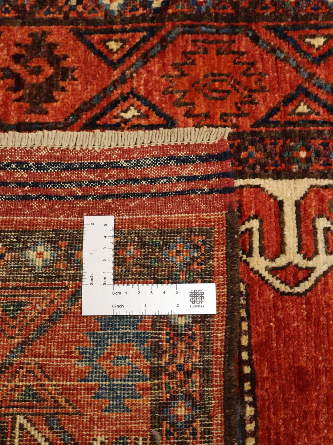 Hand-knotted Panjshir wool runner from the Middle East in red tones.