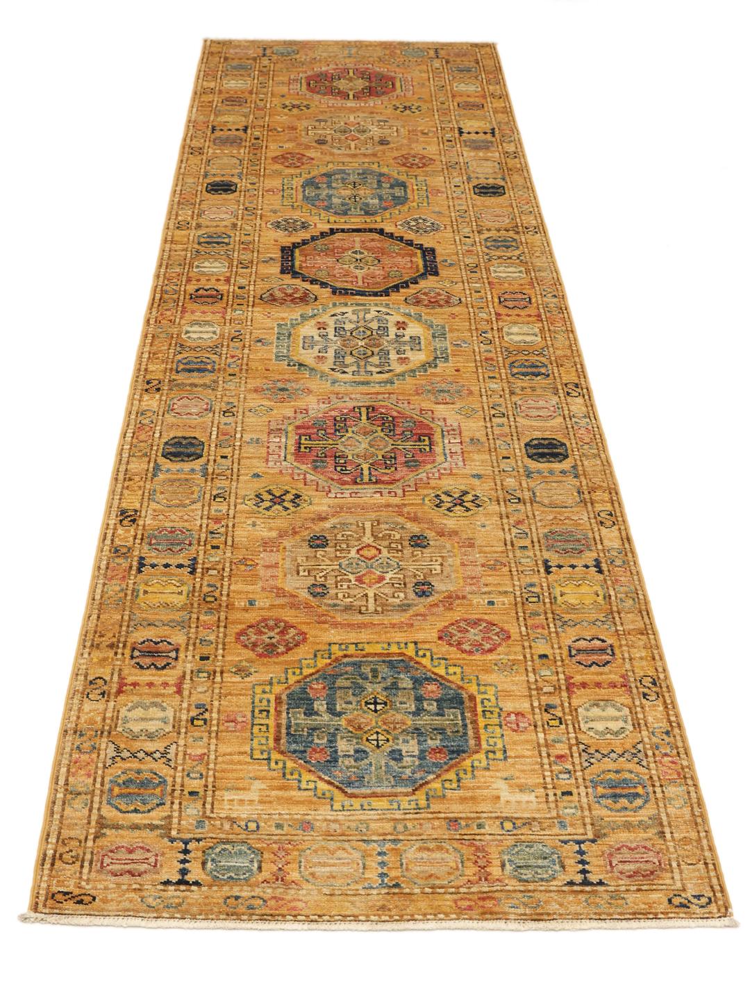 Hand-knotted Kazak Ariana runner with geometric medallions in red, blue, and gold tones from the Middle East.