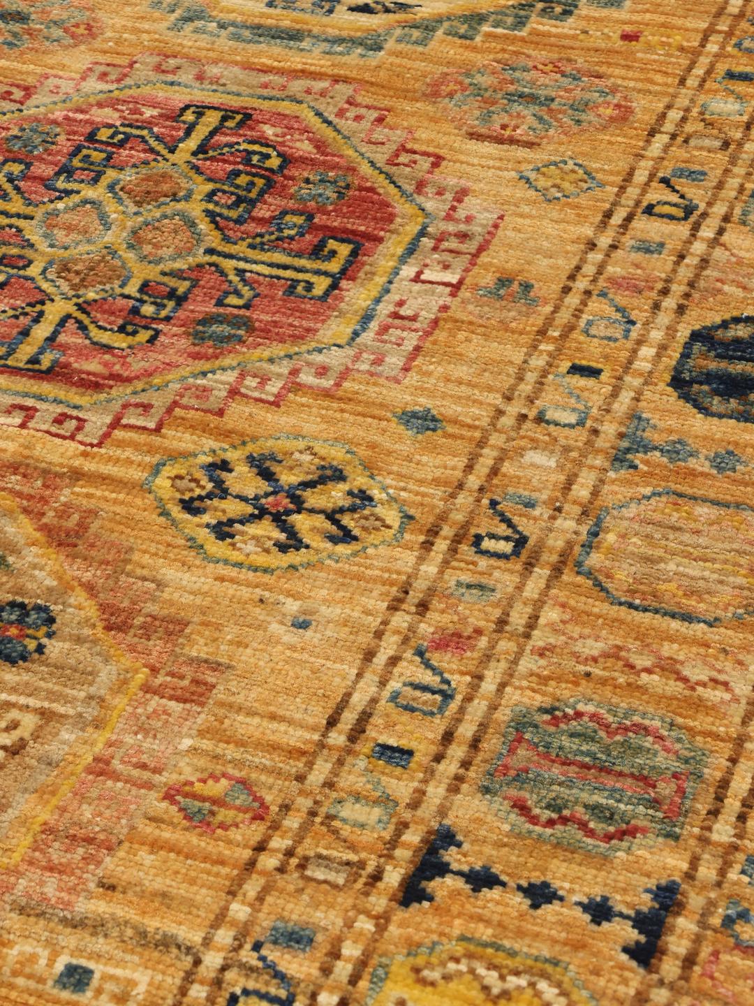 Hand-knotted Kazak Ariana runner with geometric medallions in red, blue, and gold tones from the Middle East.