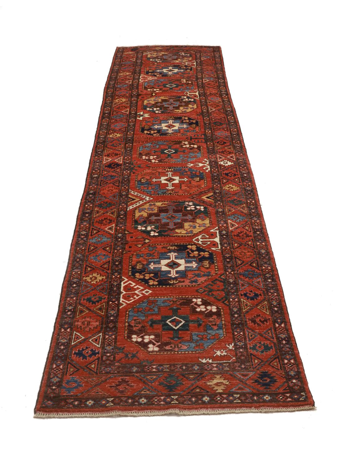 Håndknyttet afghansk løber i rød med geometriske motiver