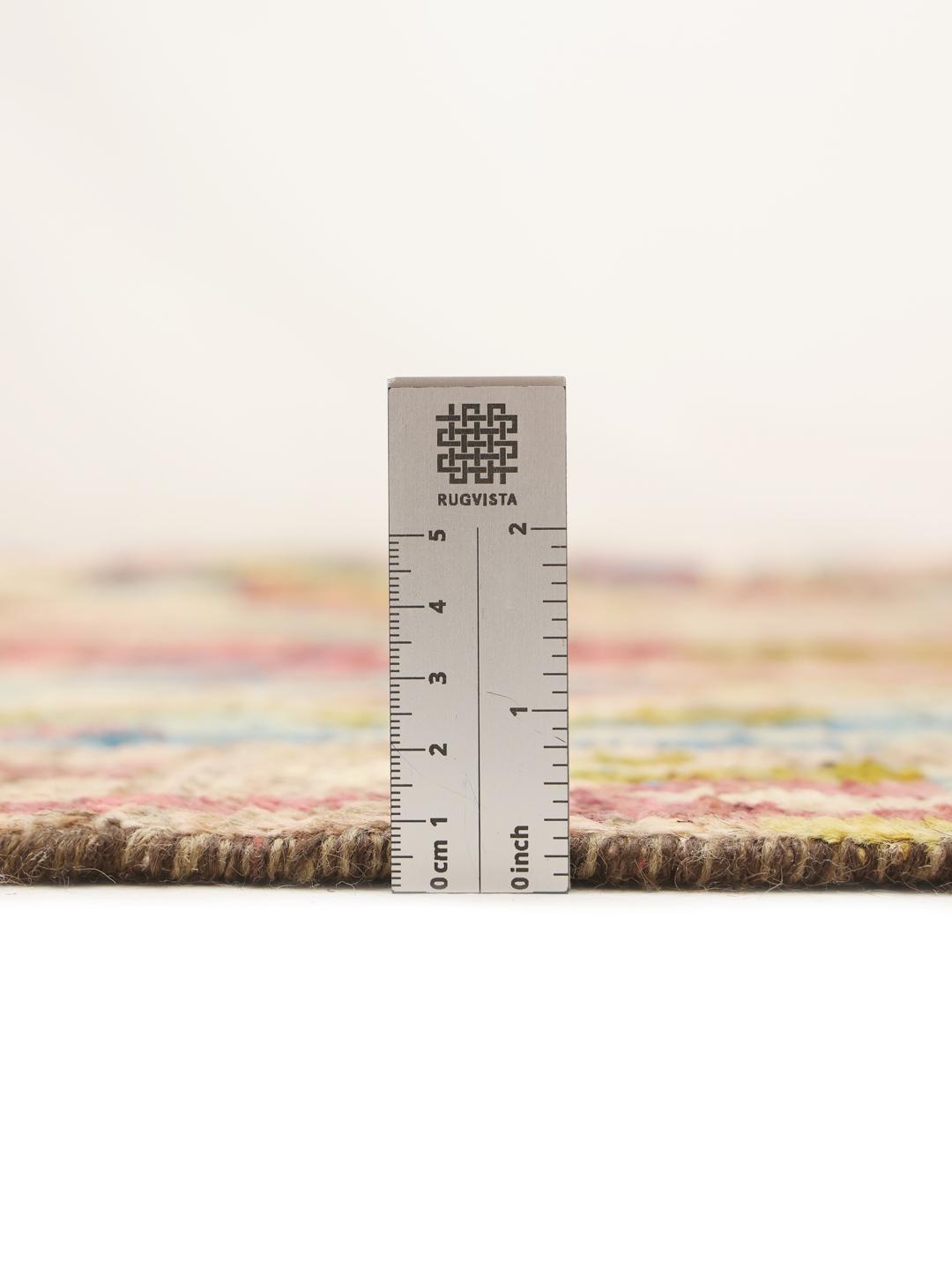 A large, hand-knotted Afghan rug featuring a vibrant, multicolored abstract pattern.