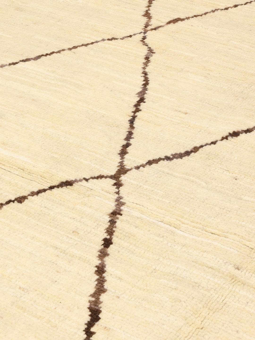 Hand-knotted Afghan rug with a beige field and dark geometric diamond pattern