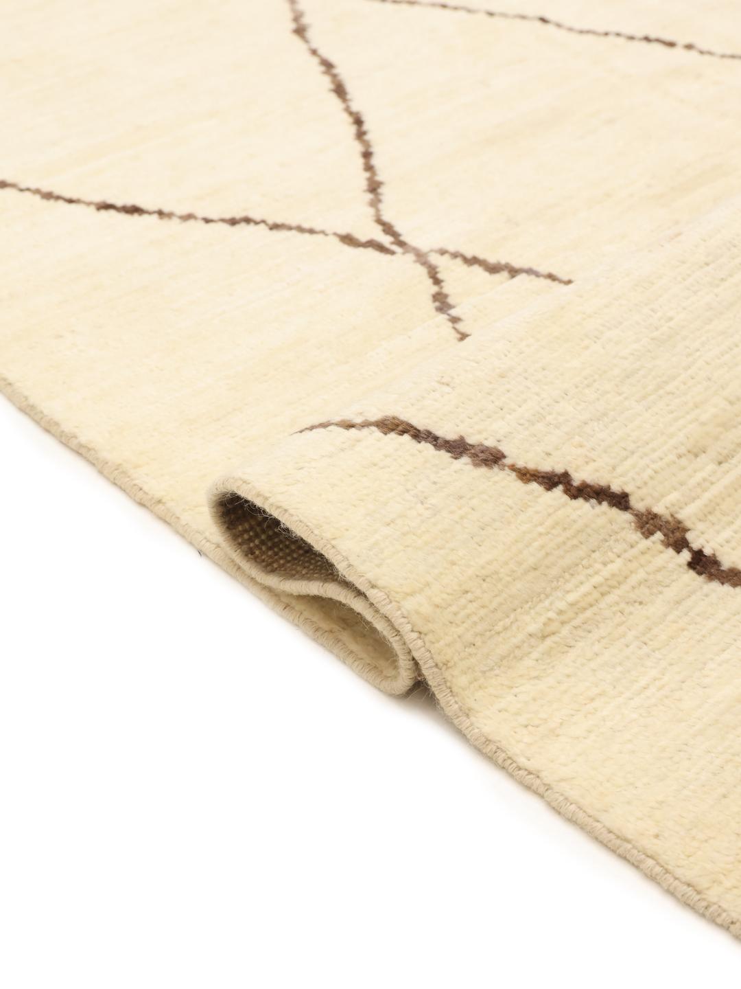 Hand-knotted Afghan rug with a beige field and dark geometric diamond pattern