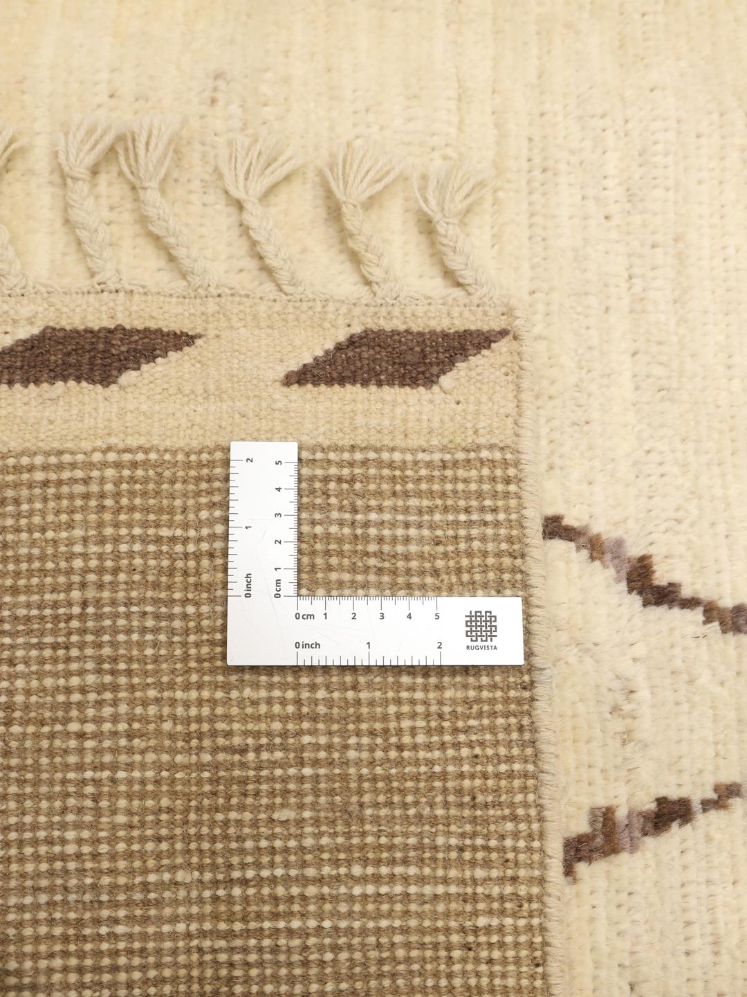 Hand-knotted Afghan rug with a beige field and dark geometric diamond pattern
