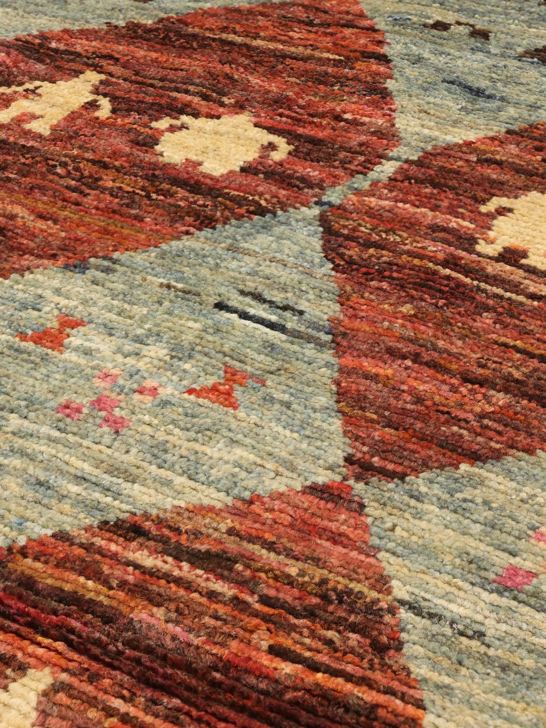 Hand-knotted Afghan rug with colourful diamond patterns and tribal motifs