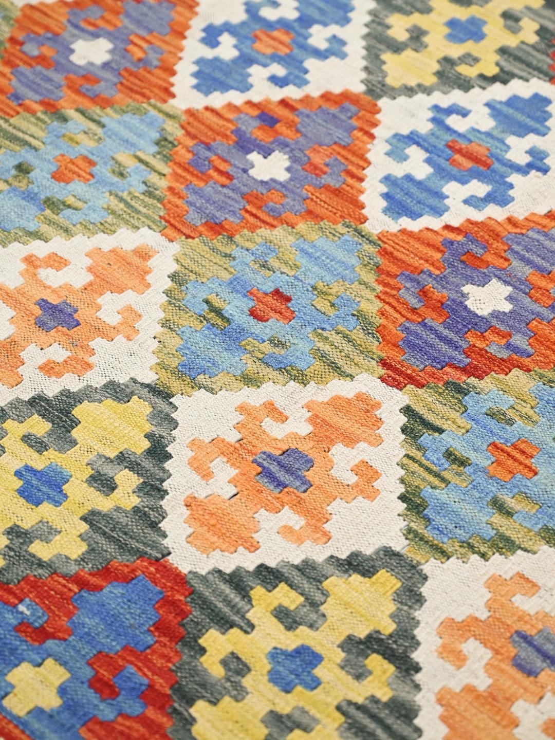 Hand-woven Afghan Kelim rug with a vibrant multicolor geometric pattern