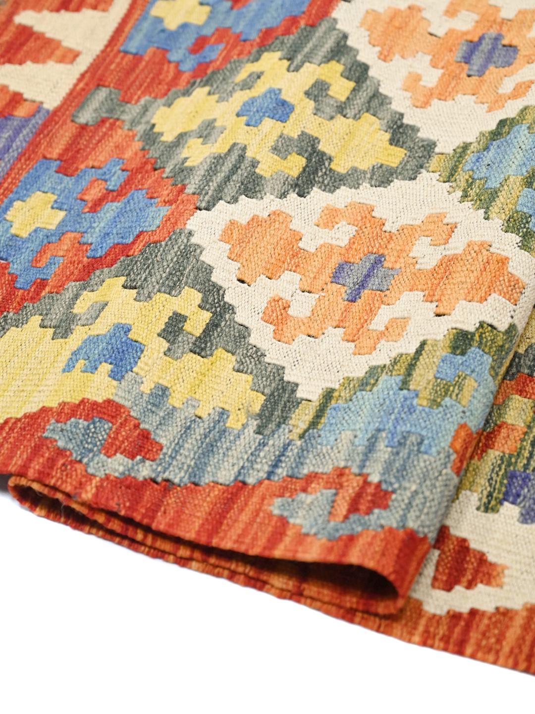 Hand-woven Afghan Kelim rug with a vibrant multicolor geometric pattern