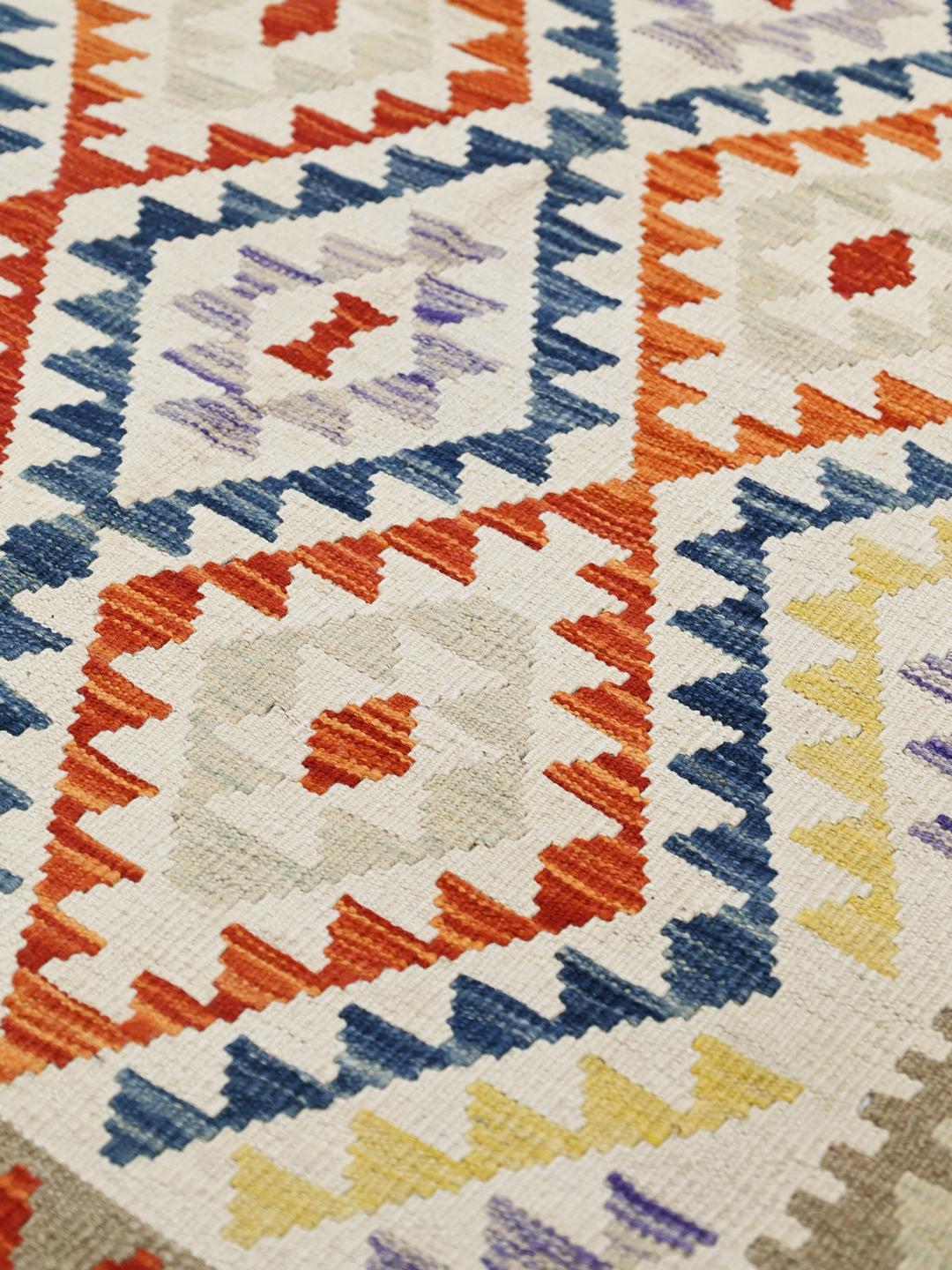 Hand-woven Afghan Kelim rug with a geometric pattern in multicolor wool.