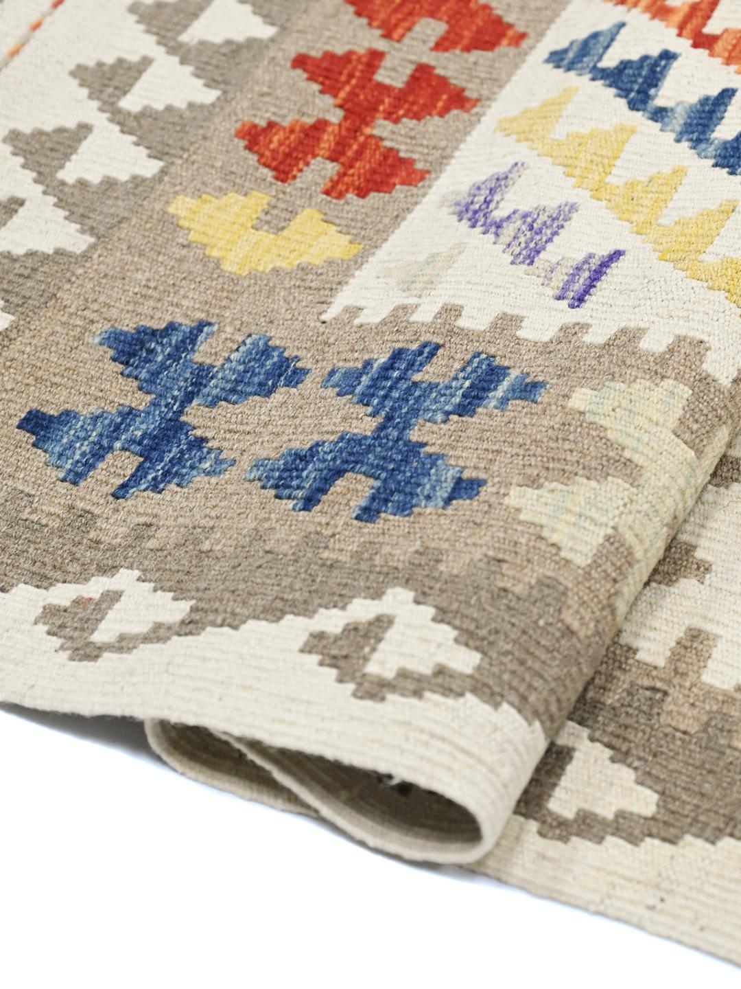 Hand-woven Afghan Kelim rug with a geometric pattern in multicolor wool.