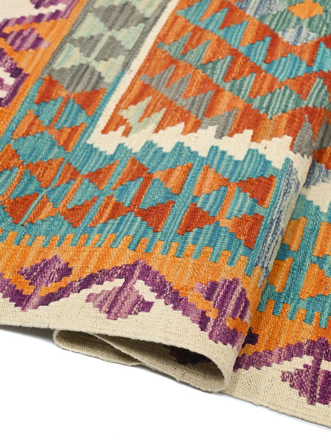 Hand-woven Afghan Kelim rug with geometric diamond patterns in vibrant multicolor tones