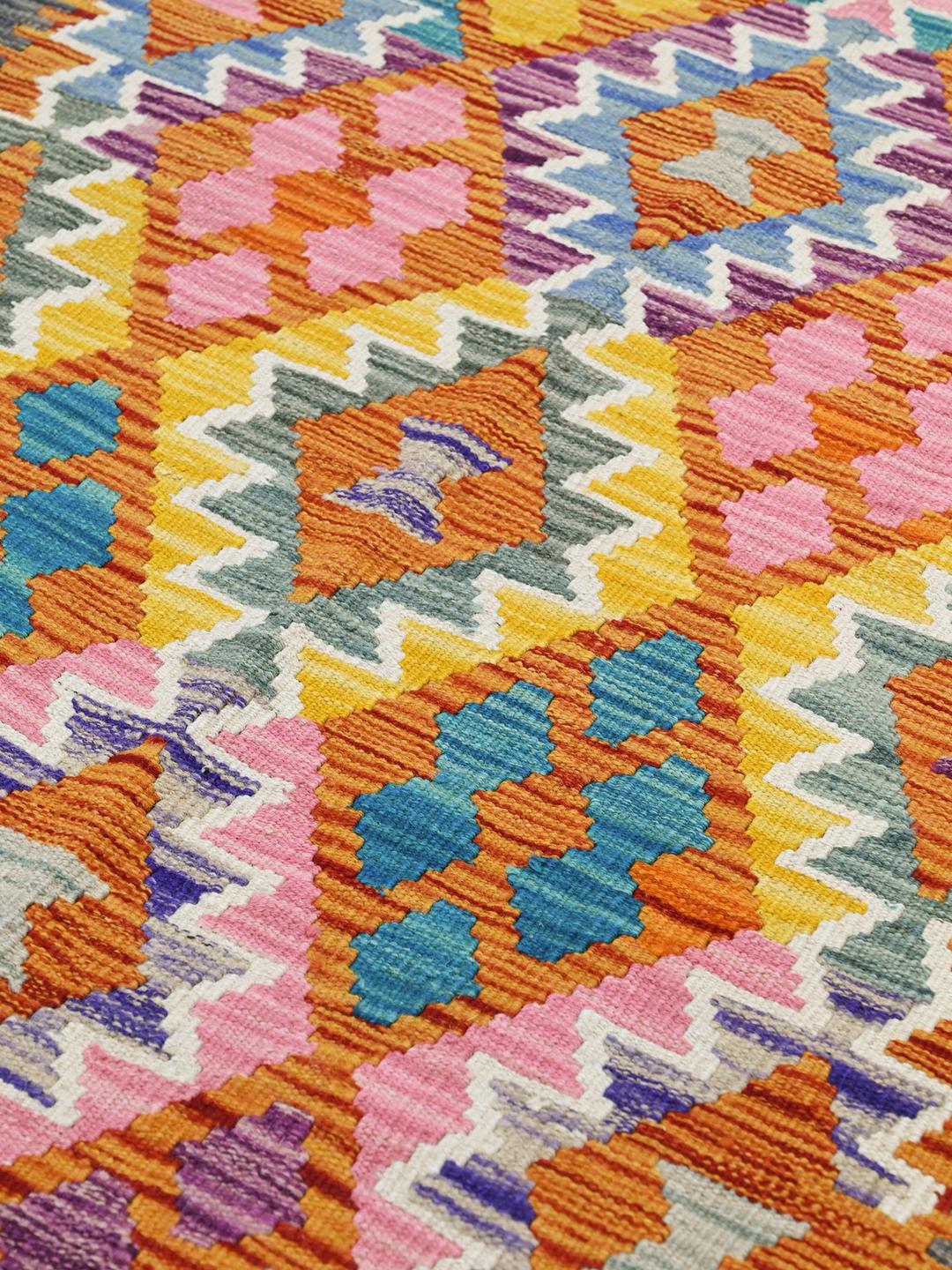 Hand-woven Afghan Kelim rug with vibrant geometric patterns in multicolour Wool.