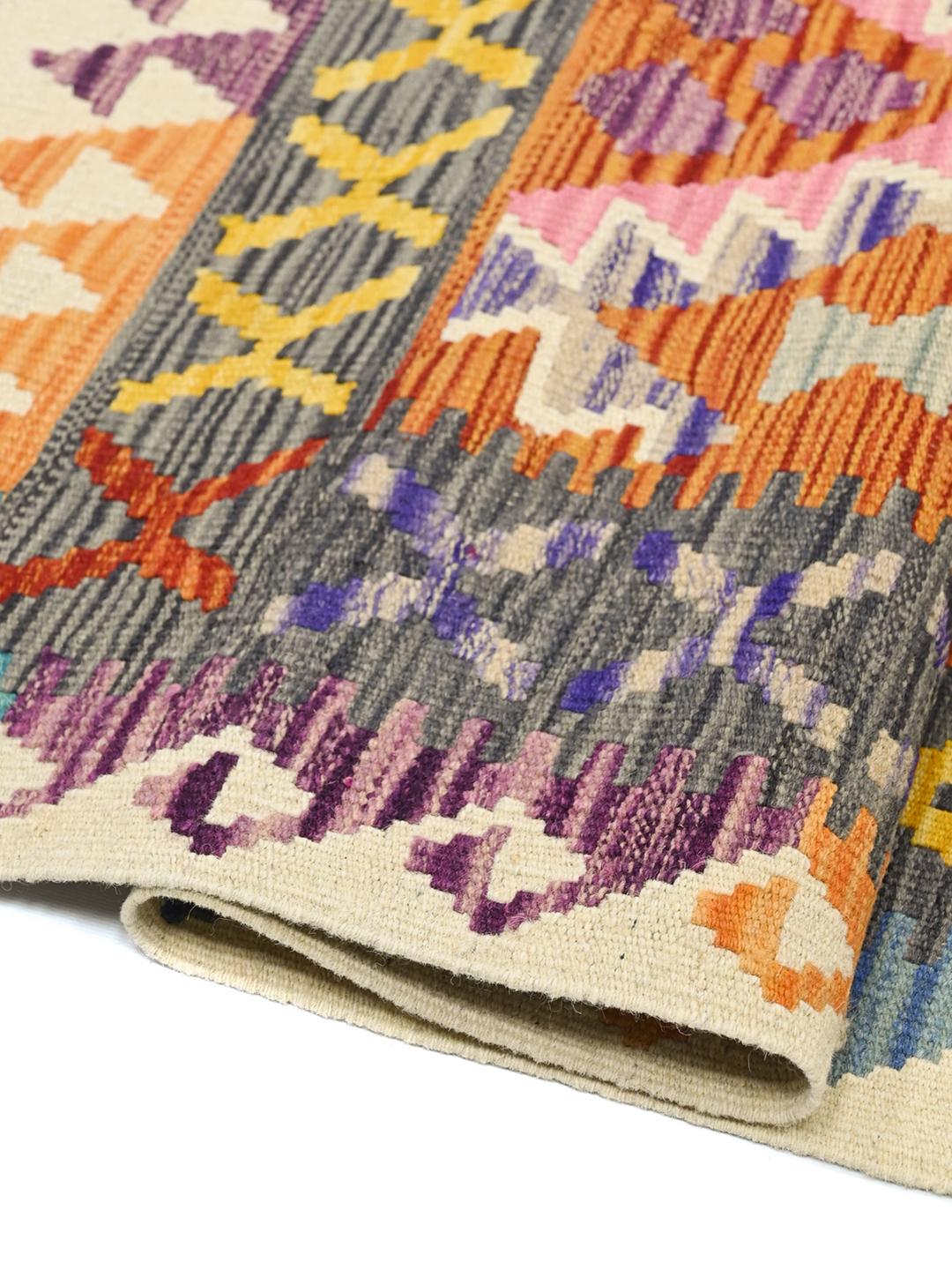 Hand-woven Afghan Kelim rug with vibrant geometric patterns in multicolour Wool.